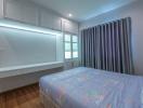 Modern bedroom with ambient lighting and wood flooring