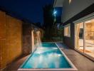 Modern home exterior with swimming pool at twilight
