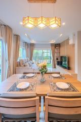 Elegant dining area with modern lighting and a view of the garden