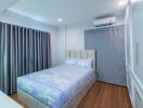 Cozy bedroom with queen-sized bed and modern air conditioning unit