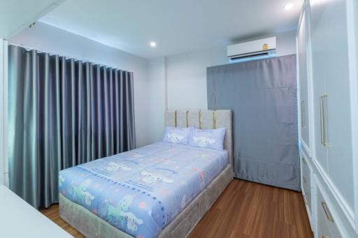 Cozy bedroom with queen-sized bed and modern air conditioning unit
