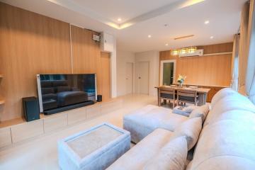 Modern living room with plush seating and wood paneling