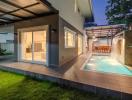 Modern house exterior with pool and patio area at dusk