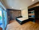 Spacious bedroom with hardwood floors and stylish wallpaper