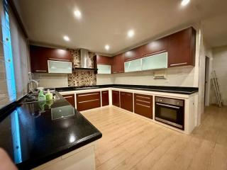 Modern kitchen with dark wood cabinets and stainless steel appliances