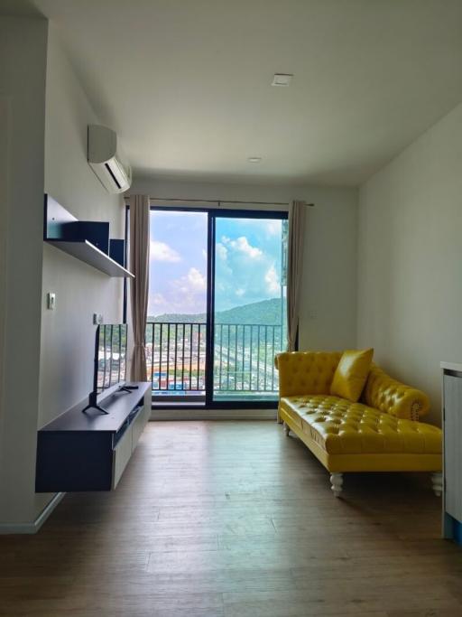 Bright living room with large windows and a yellow sofa