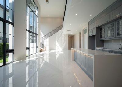 Spacious interior view of a modern building including kitchen area with natural light