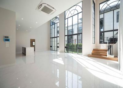 Spacious and bright modern building interior with large windows and white glossy floor