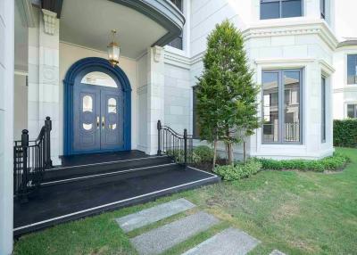 Elegant front entrance of a residential building with blue double doors