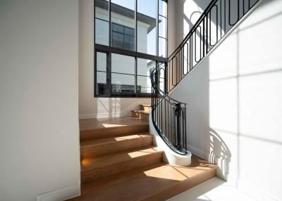 Modern staircase with large windows and elegant railing