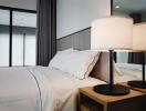 Modern bedroom with a comfy bed and elegant bedside lamp