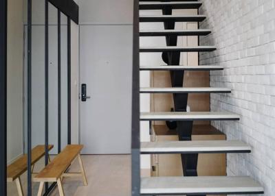 Modern staircase with white brick wall and wooden steps