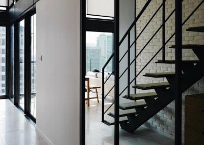 Modern living space with staircase and large windows