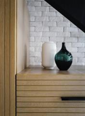 Modern interior design with decorative vases on a wooden chest of drawers
