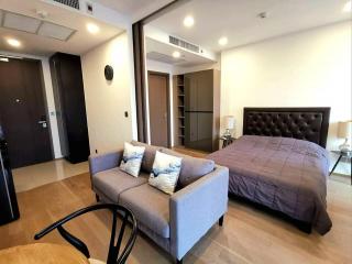 Studio apartment with combined bedroom and living space featuring modern furniture