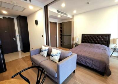 Studio apartment with combined bedroom and living space featuring modern furniture