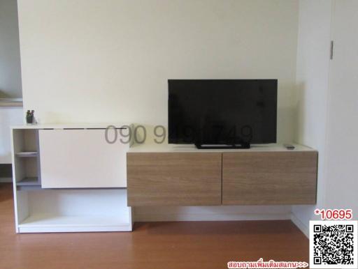 Modern minimalist living room with a wall-mounted TV and wooden console