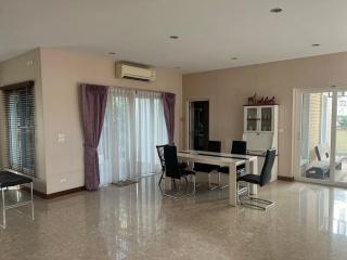 Spacious and well-lit living room with modern furniture and large windows