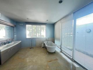 Spacious bathroom with large windows and modern fixtures