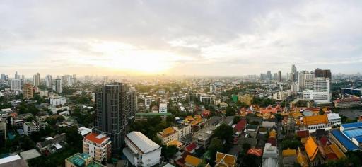 Panoramic view of a city skyline at sunset