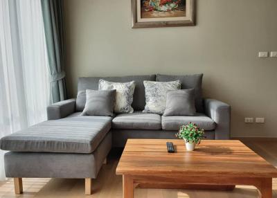 Cozy living room with a comfortable grey sofa, wooden coffee table, and elegant decor