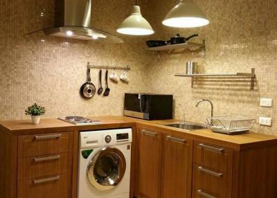 Modern kitchen with stainless steel appliances and wooden cabinets