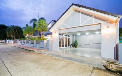 Exterior view of a modern house at dusk with lights on