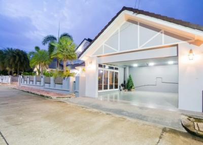 Exterior view of a modern house at dusk with lights on