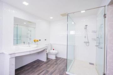 Modern bathroom with spacious glass shower and dual sink vanity