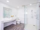 Modern bathroom with spacious glass shower and dual sink vanity