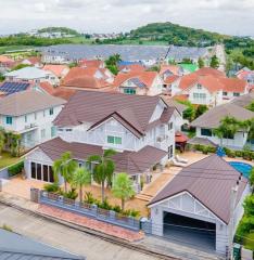 Aerial view of a residential neighborhood showcasing detached houses with well-maintained yards and varying roof designs