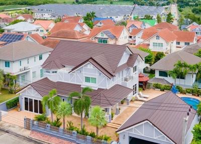 Aerial view of a residential neighborhood showcasing detached houses with well-maintained yards and varying roof designs