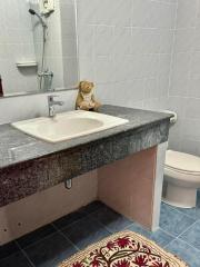 Cozy bathroom interior with blue tiles and teddy bear decoration