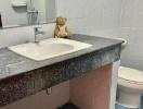 Cozy bathroom interior with blue tiles and teddy bear decoration