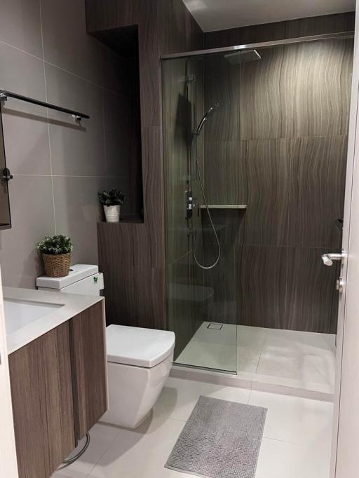 Modern bathroom with glass shower and wood accents