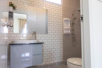 Modern bathroom with white subway tiles and grey vanity