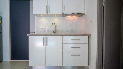 Modern kitchen with white cabinetry and under-cabinet lighting