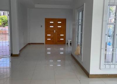 Spacious and bright empty living room with large windows and tiled floor