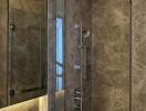 Elegant bathroom with glass shower and marble walls