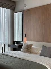 Modern bedroom with wooden headboard and sheer curtains