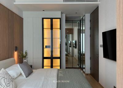 Modern bedroom with en-suite bathroom and wall-mounted TV