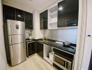 Modern kitchen with stainless steel appliances and black cabinetry