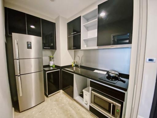 Modern kitchen with stainless steel appliances and black cabinetry