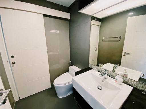 Modern bathroom with white fixtures and dark walls