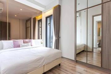 Modern bedroom interior with king-sized bed and mirrored wardrobe