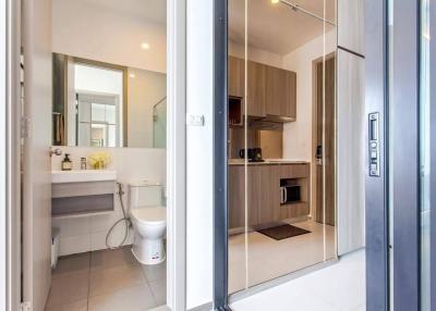 Modern bathroom and kitchen interior through open door