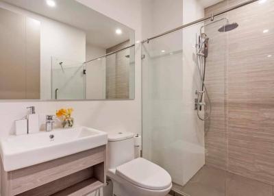 Modern bathroom with glass shower and white fixtures