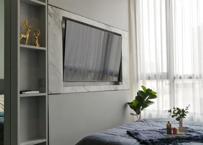 Modern bedroom with a wall-mounted TV and minimalist decor