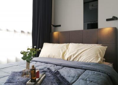 Cozy modern bedroom with a neatly made bed and decorative elements
