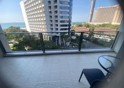 Spacious balcony with a view of the ocean and surrounding buildings